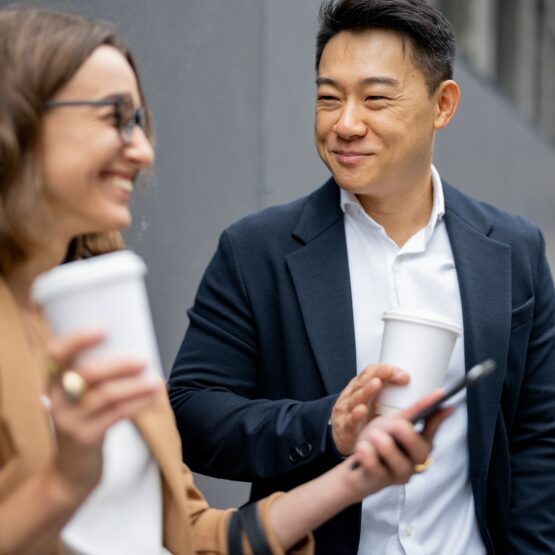 Business people drink coffee and talk in city