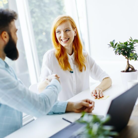 Business people shaking hands and finishing up a meeting