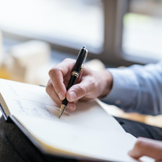Close-up of businessman taking notes in office