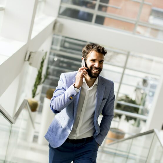 Handsome businessman in suit using the phone