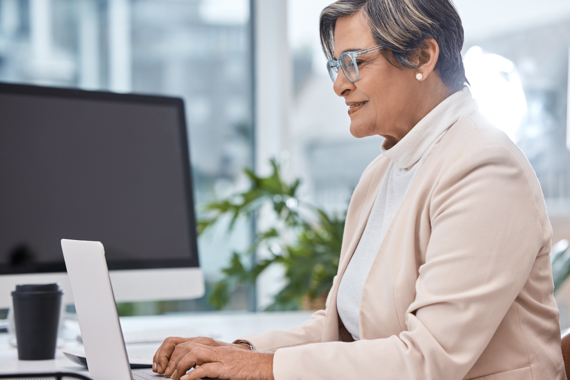 Shot of a mature businesswoman working on a laptop in an office