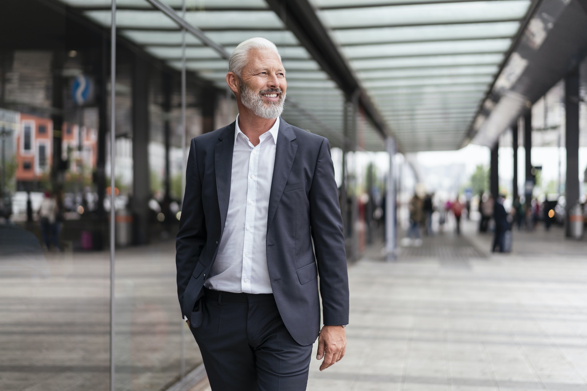 Smiling mature businessman in the city on the go